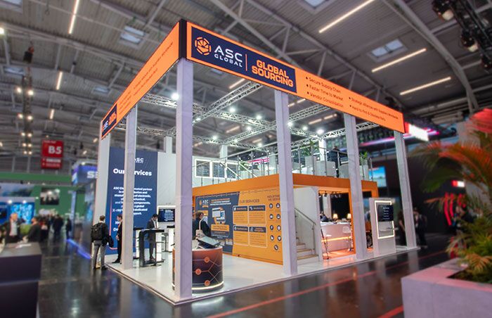 asc_global_booth_electronica_2024_01 Image of ASC Global's two-story booth displayed at the Electronica 2024 trade show, featuring a modern design showcasing their services and capabilities in the electronic components industry