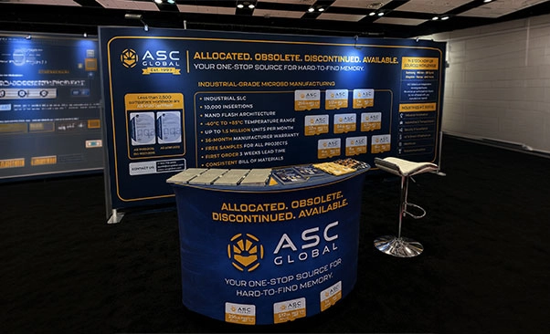 ASC Global's FMS 2026 booth featuring a large printed banner highlighting the company's industrial-grade MicroSD manufacturing capabilities, including product benefits, manufacturing capacity, reliability, and supply chain solutions.