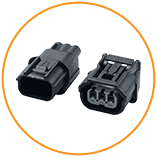 Variety of electronic connectors arranged on a surface, showcasing one of the key component categories offered by ASC Global for reliable electrical connections